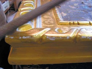 A rasp is used to make chips marked along the outside edge of the frame to replicate the dings a frame receives over time.